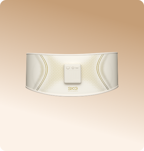 Pas treningowy SKG GS300 w kolorze beżowym, z panelem sterowania i wzorem w złote kropki na środku